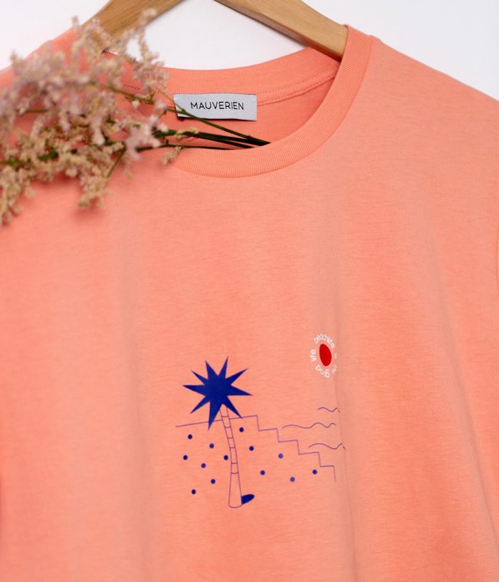Close-up of a blue palm print with small red circle and beachlife is the good life message.