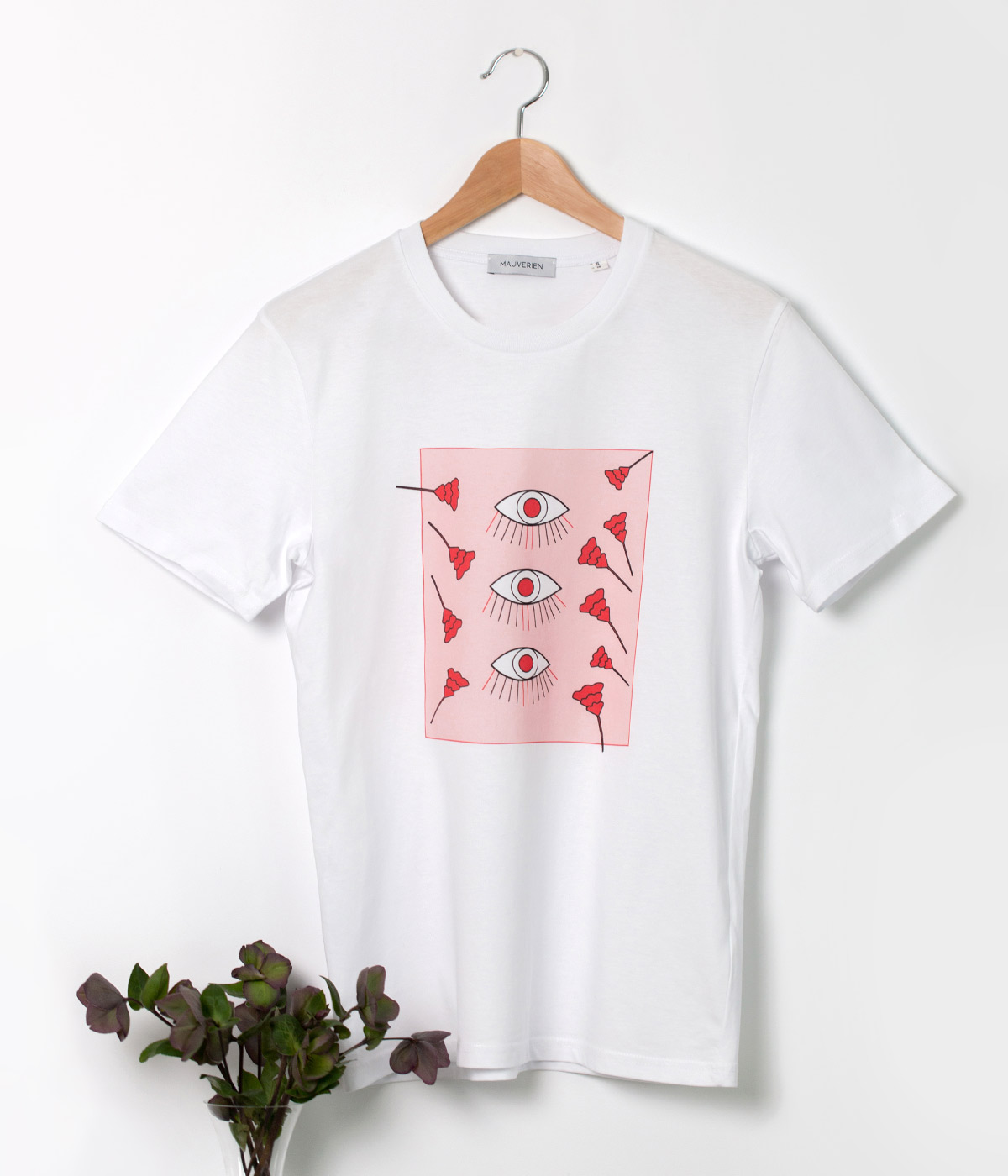Front of white cotton t-shirt printed with 3 eyes & floral motifs in red and pink.