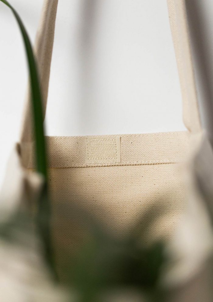 The inside of a cotton tote bag with velcro closure.