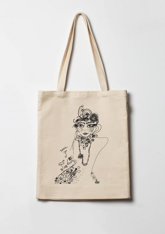 Beige cotton tote bag with black print of a girl with pearls and a handwritten I love fashion message.