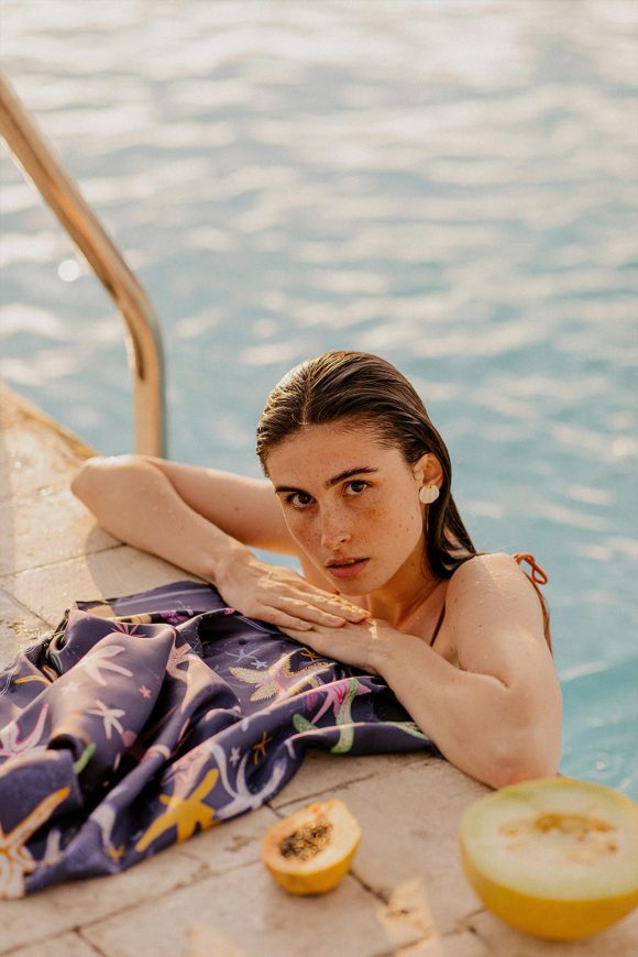 Woman by the pool with navy blue silk scarf La Mer by Mauverien.