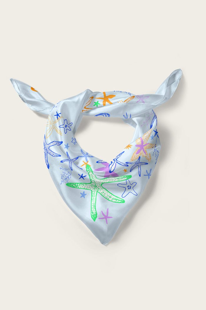Folded blue silk scarf with starfish pattern created by Romanian designer Mauverien.