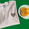 Light pink t-shirt with heart print and Mauverien label.