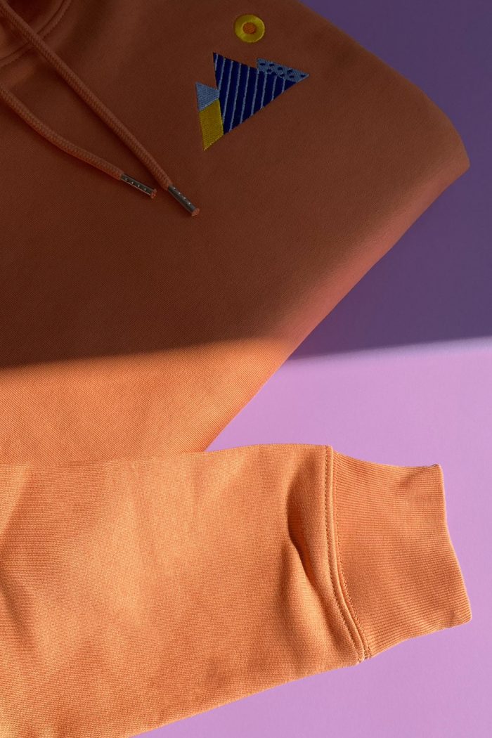 Sleeve detail of orange hoodie by Romanian designer Mauverien.