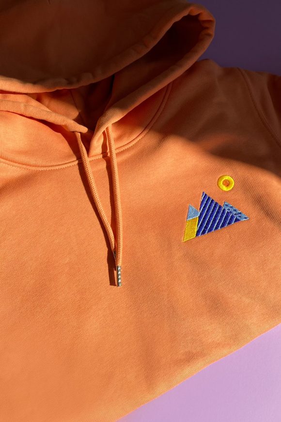 Mens Orange Hoodie with blue Mountains embroidery.